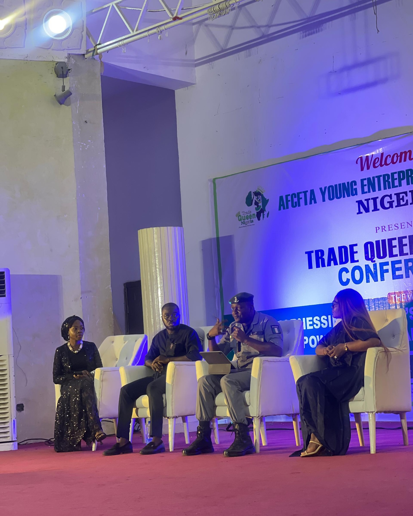 Speakers in discussion on stage at a trade conference